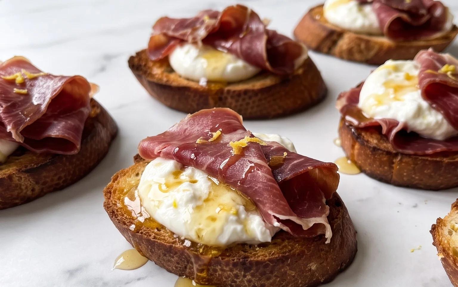 Beef Prosciutto Crostini with Burrata and Lemon Honey Drizzle